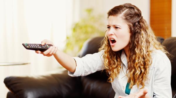 woman annoyed with TV