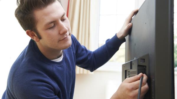 man checking TV cables